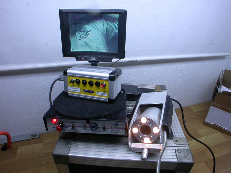 A Chim-Scan® Controller/Monitor with a clear image and a cylindrical camera with bright lights.