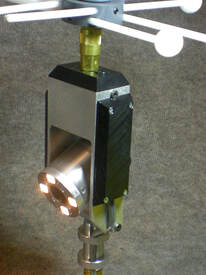 A cylindrical Chim-Scan® chimney camera is shown in a metal bracket.